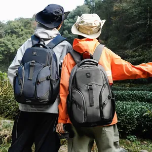Navy blue and grey large capacity hiking backpacks for men in outdoor mountain setting