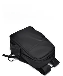 Close-up of black commuter backpack featuring waterproof matte fabric and side drawstring pocket