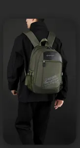 Rear view of model wearing army green nylon backpack with smart storage features