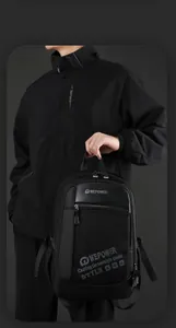 Close-up of black tactical backpack detail showing durable nylon texture and leather trim