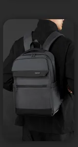 Detail of grey waterproof business backpack with side USB charging port and sleek logo