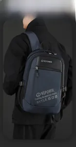 Detail of navy blue nylon backpack with multiple zipper pockets and brand lettering