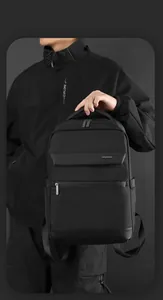 Macro shot of waterproof black business backpack featuring premium textured fabric and leather