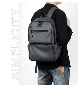 Detail view of water-resistant dark grey business backpack with dual front zipper pockets