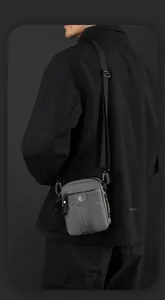 Detail of gray men's shoulder bag featuring adjustable strap and matte nylon texture