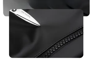 Detail shot of scratch-resistant black waterproof fabric being tested with scissors