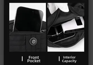 Detail view of the black crossbody bag showing front pocket and spacious main compartment