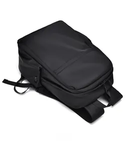 Top view of large black commuter backpack showing waterproof nylon fabric and handle