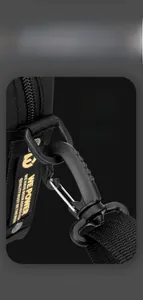 Detail of detachable shoulder strap with high-strength plastic buckle on black nylon bag