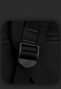 Macro shot of durable nylon fabric and plastic strap adjustment buckle on a black backpack
