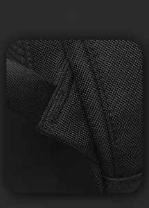 Detail of high-density waterproof fabric and reinforced stitching on a black backpack