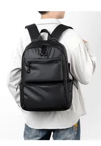 Rear view of man wearing minimalist black waterproof business travel laptop backpack
