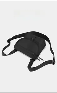 Macro view of black nylon crossbody bag featuring durable woven texture and zipper details