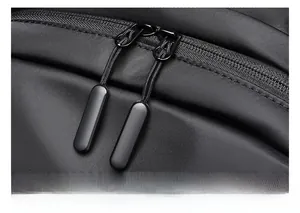 Close-up of the smooth two-way black zippers on the high-density nylon commuter backpack