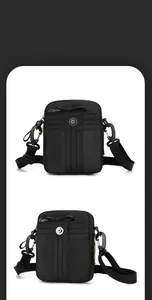 Detail of compact black nylon shoulder bag with zipper and metal buckle clip
