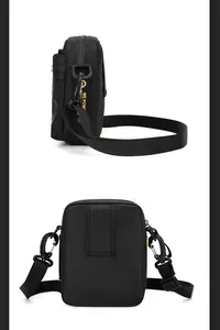 Detail of black crossbody bag with yellow strap, showing the belt loop and side profile