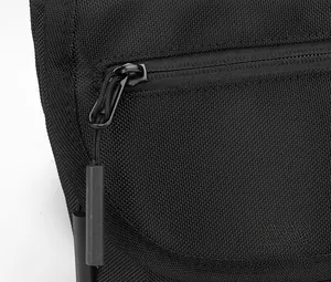 Macro detail of high-density black nylon fabric texture and durable zipper puller