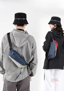Detail view of blue and red waterproof nylon crossbody bags on male and female models