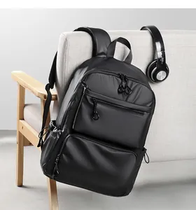 Detail of waterproof black business backpack with multiple circular zipper pockets