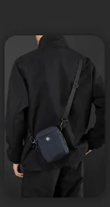 Detail view of the deep blue waterproof nylon crossbody bag with adjustable strap