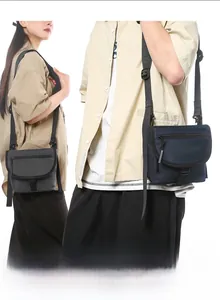Detail of waterproof nylon crossbody bag with flap buckle closure and adjustable strap
