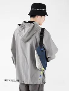 Detail of color-block sling bag featuring neon drawstring and adjustable nylon strap