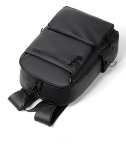 Top view of a black business travel backpack featuring waterproof matte fabric and zippers