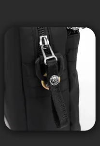 Detail of durable nylon fabric with silver metal zipper and decorative strap handle