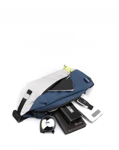 Detailed macro view showing large capacity and multi-pocket storage of the sling bag