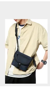 Close-up of navy blue nylon messenger bag with buckle closure and adjustable strap