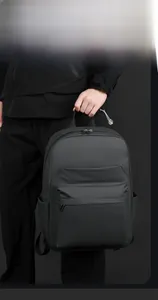 Close-up of waterproof matte black business backpack with large front zipper pocket detail
