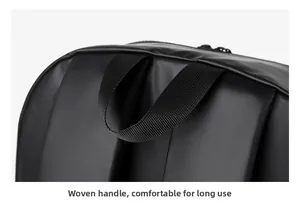Close-up of a black backpack with a wide high-density woven handle and padded straps
