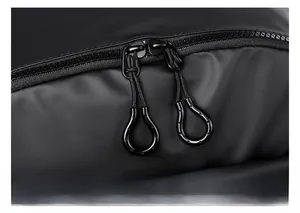 Close-up of durable dual zippers with easy-pull loops on black waterproof backpack
