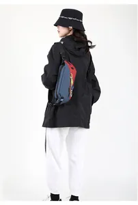 Detail of navy blue and red color-block crossbody bag with yellow zipper accents