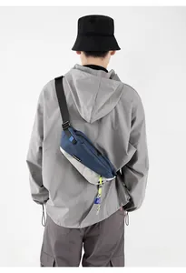 Detail of blue and gray color-block crossbody bag with adjustable strap for urban commuting