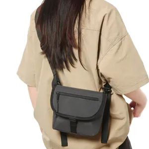 Deep grey urban functional nylon crossbody bag with wide shoulder strap and buckle closure