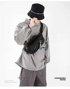 Detail of color-block techwear waist bag with neon green zippers and blue straps