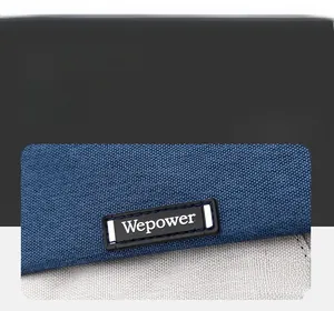 Close-up of the Wepower brand logo patch stitched on the blue and gray canvas cycling bag