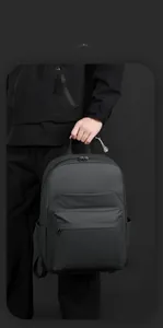Detail of minimalist black waterproof business backpack with smooth matte texture and side pocket