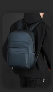 Rear view of a navy blue waterproof business backpack showing smart storage design
