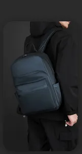 Detail view of water-resistant navy business backpack with hidden front zipper pocket