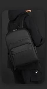 Male model wearing black business backpack with smart storage space in studio
