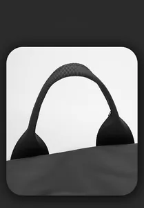 Detail of reinforced nylon handle and matte waterproof fabric on black laptop backpack