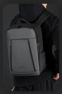 Man wearing a large water-resistant business backpack with vertical zipper pockets