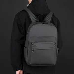 Modern men business casual waterproof backpack in matte black worn by a male model