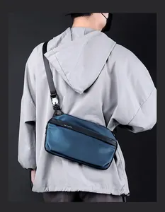 Gros plan du sac bandoulière en nylon imperméable avec sangle réglable et logo