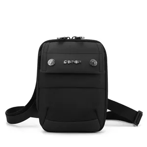 Minimalist black nylon crossbody bag with dual zippers and adjustable wide shoulder strap