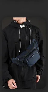 Detail of navy blue multi-pocket nylon chest bag showing water-resistant fabric and zippers
