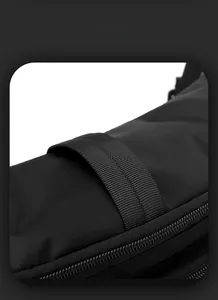 Detail of waterproof nylon fabric with sturdy top handle and zipper on black chest bag