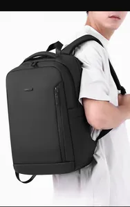 Side view of man wearing a sleek black business backpack with waterproof honeycomb texture